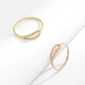 Titanium steel ring with micro-pave zircons in gold and rose gold on a white podium