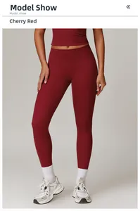 Detailed view of high-waisted cherry red yoga pants with brushed matte texture finish