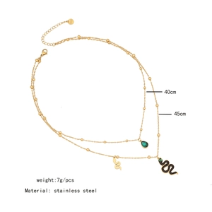 Double-layer stainless steel gold necklace with snake pendant and green teardrop detail