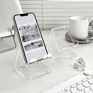 Clear acrylic desk phone stand holder with anti-slip pads in a minimalist office setup