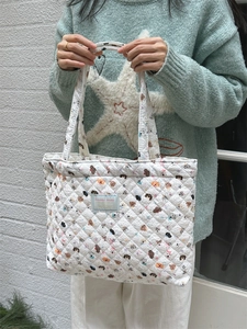 Quilted white cotton tote bag featuring colorful cartoon dog prints and dual handles