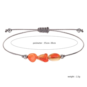 Handmade woven cord bracelet with irregular orange birthstones and silver metallic beads