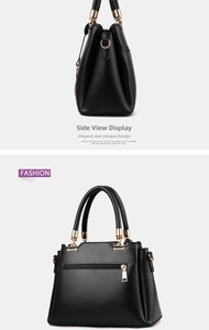 Detail of black pebbled leather handbag with gold hardware and back zipper pocket
