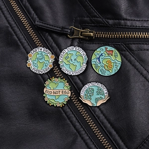 Detail of five creative Earth Day enamel pins on black leather jacket zipper area