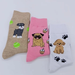 Detailed flat lay of three pairs of cotton socks featuring cute cartoon dog patterns