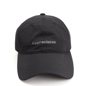 Detailed view of the letter embroidery and quick-dry nylon fabric on the baseball cap