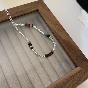 Detail of colorful gemstone beaded bracelet with silver squares and lobster clasp extension