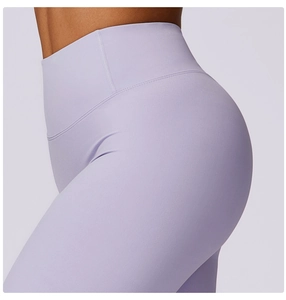 Detail view of high-waist lilac yoga pants showing moisture-wicking fabric and seamless fit