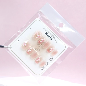 Elegant cat-eye press-on nails with peach blossom design in pink set on display card