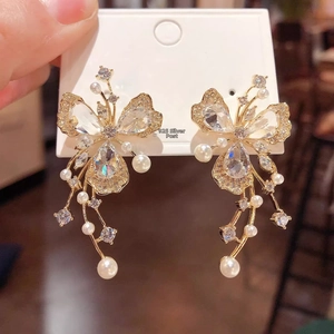 Detail of luxury butterfly earrings with S925 silver needles, pearls and crystal tassels