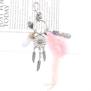 Pink dreamcatcher keychain with feather, crystals, and silver Hamsa hand charm