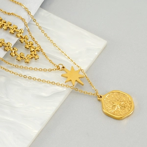 Three-layer stainless steel necklace featuring star and hammered coin pendants in gold finish