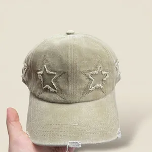 Close-up of vintage khaki baseball cap with star embroidery and distressed ripped details