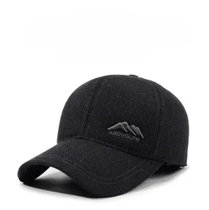 Detailed close-up of side embroidery and warm ear flap on a thick grey wool baseball cap