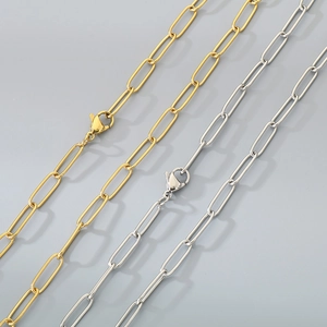 Detail view of paperclip link chains in gold and silver finish with high metal texture