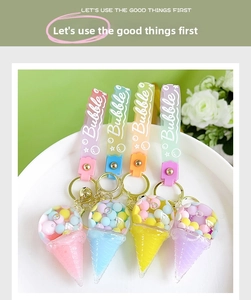 Close-up of colorful acrylic ice cream keychains with pastel liquid sand and bells