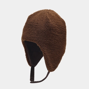 Detail view of brown sherpa fleece earflap hat with soft thick lining and adjustable strap