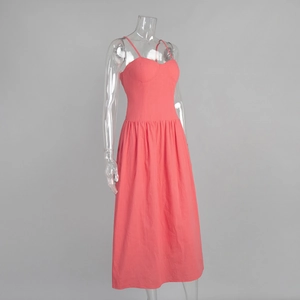 Detail view of pink cotton sundress with smocked waist and delicate spaghetti straps