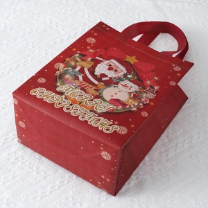 Red Christmas non-woven gift bag with Merry Christmas print and cartoon Santa design