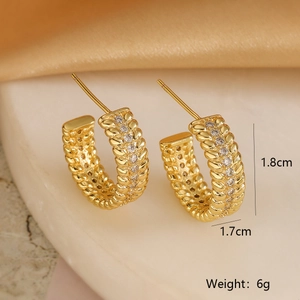 Macro view of 18K gold plated woven C-hoop earrings with sparkling zircon inlay details