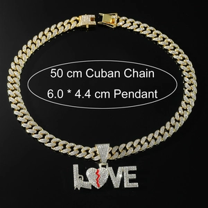 Close-up of iced out LOVE pendant with broken heart on a 50cm golden Cuban chain