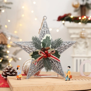 Silver glitter star ornament with pine needles and red berries on a wooden base