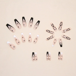 Long coffin press-on nails with black and white star patterns and rhinestone accents