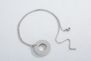Detail of silver MOM pendant with embedded rhinestones and delicate metal chain