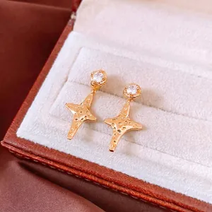 18K gold plated star earrings with white zircon on brown leather jewelry box