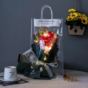 Detail of red soap rose bouquet with LED lights in a transparent PVC gift bag