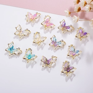 Detail of 11 gradient resin butterfly nail charms with gold trim and inlaid pearls