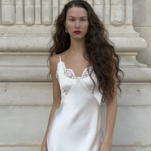 Elegante vestido lencero de satén blanco con escote en V de encaje y largo medio