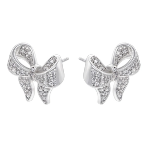 Macro shot of silver bow earrings with pavé set zircons and dangling tassel detail
