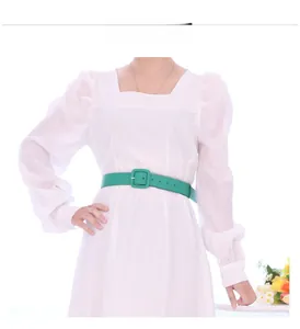 Close-up of bright green waist belt with square pin buckle styled on white dress