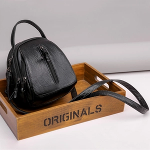 Fashionable black pebbled leather crossbody bag with multiple zipper compartments