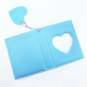 Detail of blue 3-inch photo album featuring heart-shaped cutout and matching heart pendant