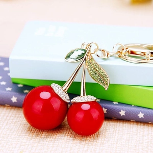 Sparkling cherry car keychain with red rhinestones and gold metal leaf decoration