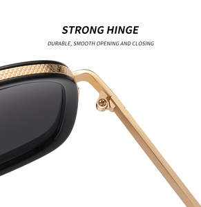 Detail of strong metal hinges on black square frame sunglasses with gold accents