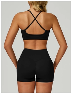 Detailed back view of a black sports bra featuring a thin cross-strap design and high waist
