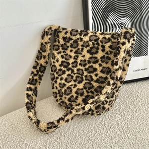 Detailed texture of leopard print faux fur material on a stylish large shoulder bag