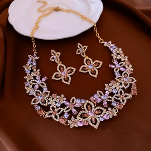 Exquisite flower jewelry set with purple and pink crystals on gold chain and earrings