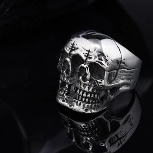 Punk style stainless steel skull ring with three-faced ghost design and polished silver finish