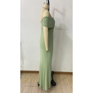 Detail of off-shoulder sequin dress in light green with shimmering fabric and slim fit