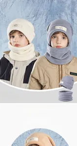 Close-up of winter children's hat and scarf set with thick fleece lining and mountain label