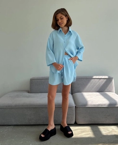 Detail of light blue waffle knit loungewear set featuring soft textured fabric and loose fit