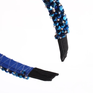 Blue layered headband with sparkling crystals and silver beads on a clean white background