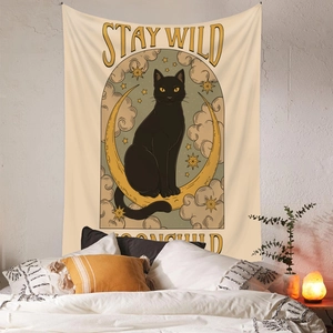 Detail view of Bohemian cat tapestry with Stay Wild Moonchild text over a cozy bed