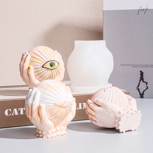 Silicone mold for DIY candle or resin art featuring unique hands holding eyeball design