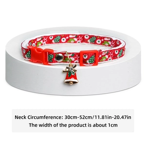 Detail of Christmas pet collar with adjustable size markings and red bell charm