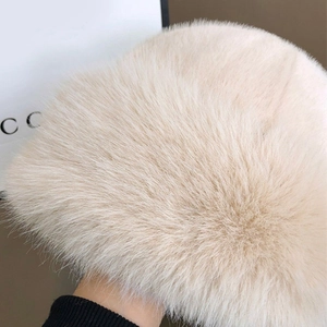 Close-up of soft plush faux fur texture on the creamy white winter bucket hat